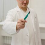 a man in a lab coat holding a toothbrush