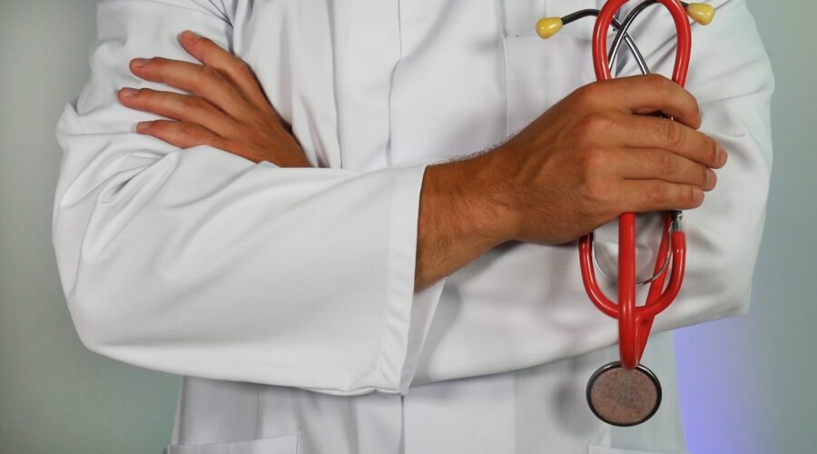 doctor holding red stethoscope